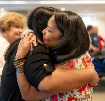 Community members embracing at SPOT6 event